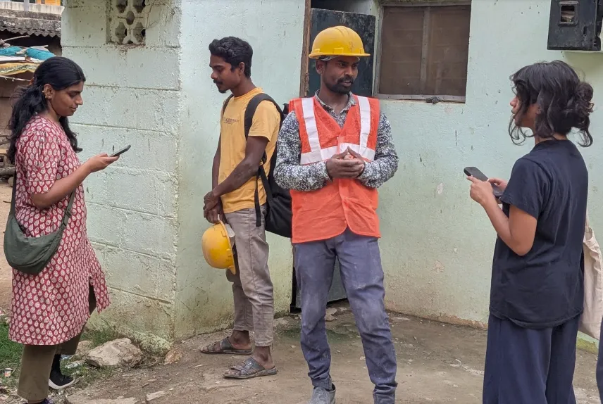 Masters in Development Practice student Manini Menon (left) and Masters in Climate Science student Siddhi Vora (right) interview migrants from rural areas who are working in the construction sector. 