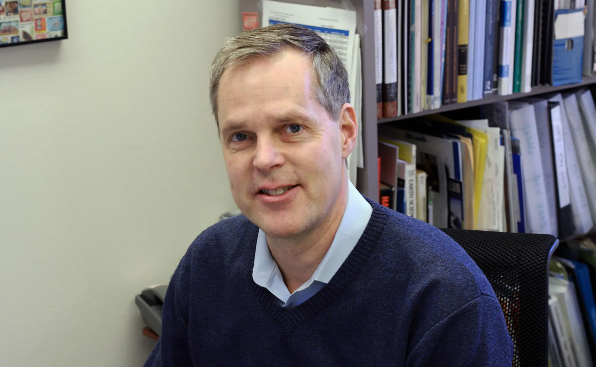 Photograph of new CIESIN director Alex de Sherbinin sitting at his desk.