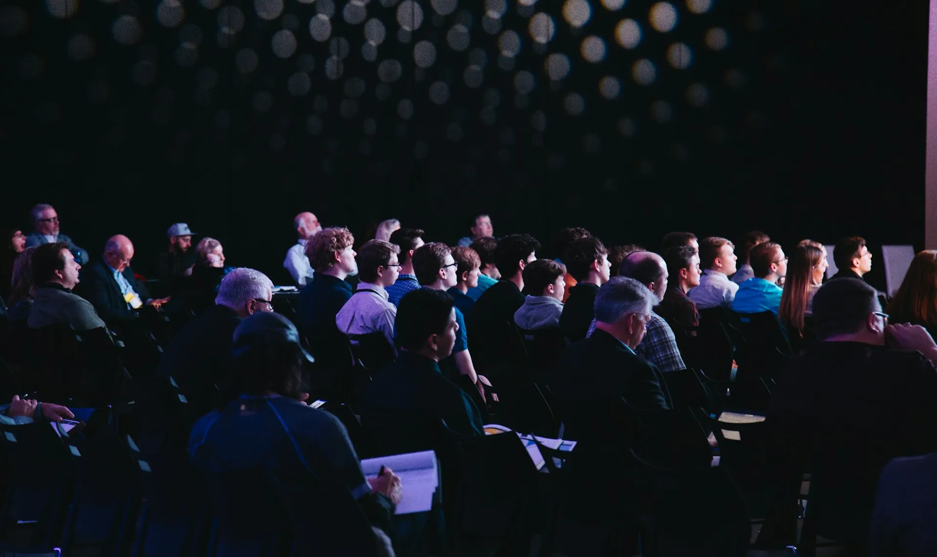 Crowd of people sitting on chairs inside room. Photo by Headway on Unsplash